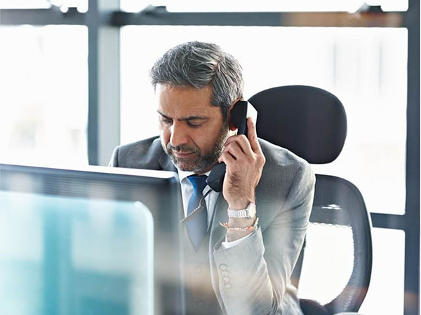 Middle age executive holding a phone